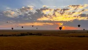 View of sunrise looking at several balloons in the sky, on the Maasai Mara Hot Air Balloon Adventure