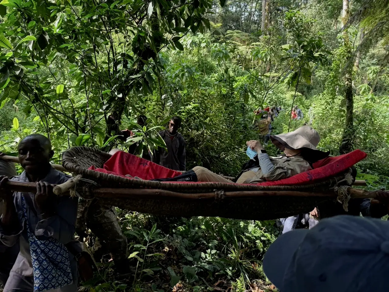 A woman being transported through the jungle in Uganda