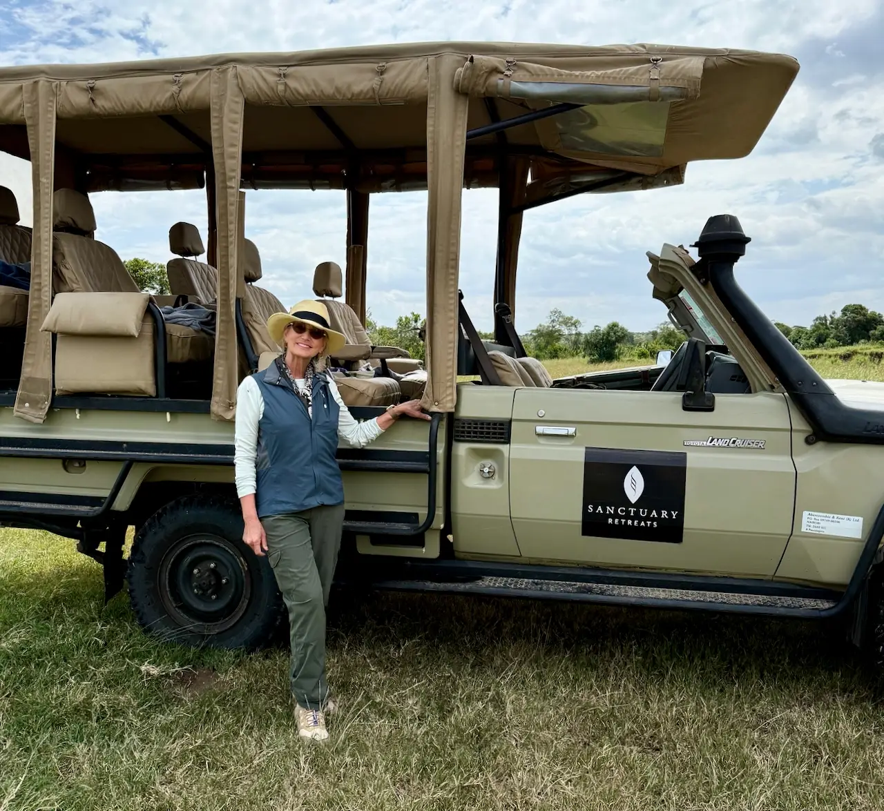 Author posing in front of a jeep, Kenya.